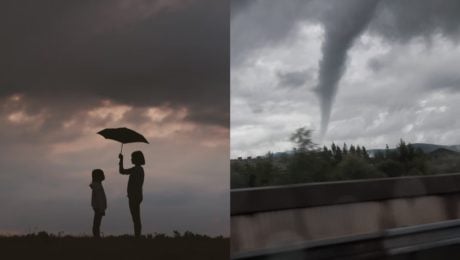 Na snímke je žena a dieťa poddáždnikom a tornádo.