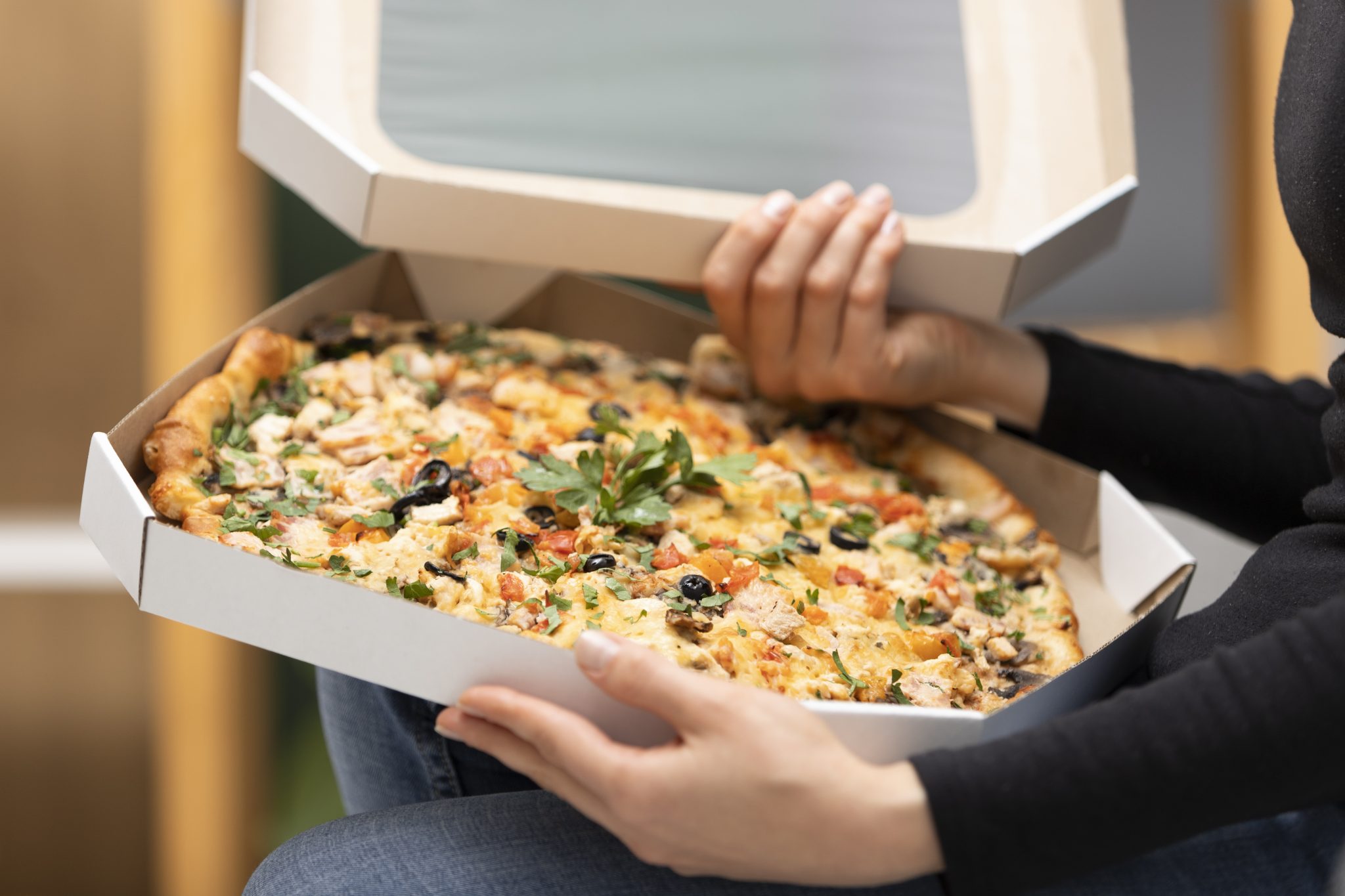 close-up-hands-holding-pizza-boxes