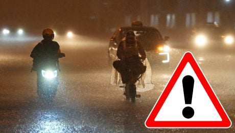 Autá a motocyklisti jazdia na ceste počas búrky