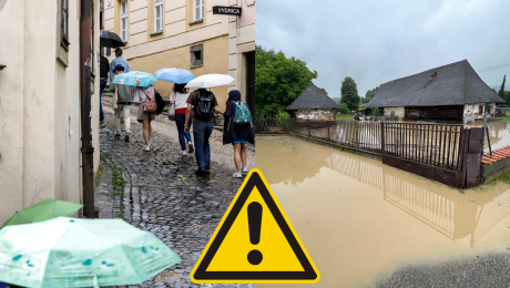 Ľudia s dáždnikmi kráčajú hore ulicou a vytopený preistor pre domom.