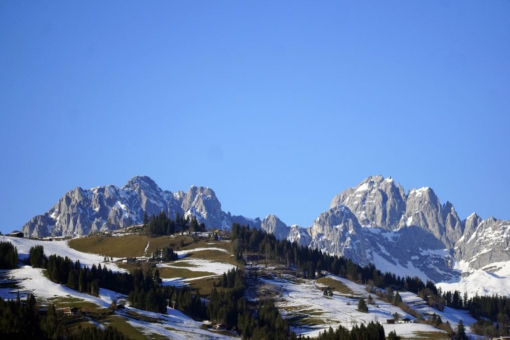 high-angle-shot-beautiful-snowy-valley-rocks-sky