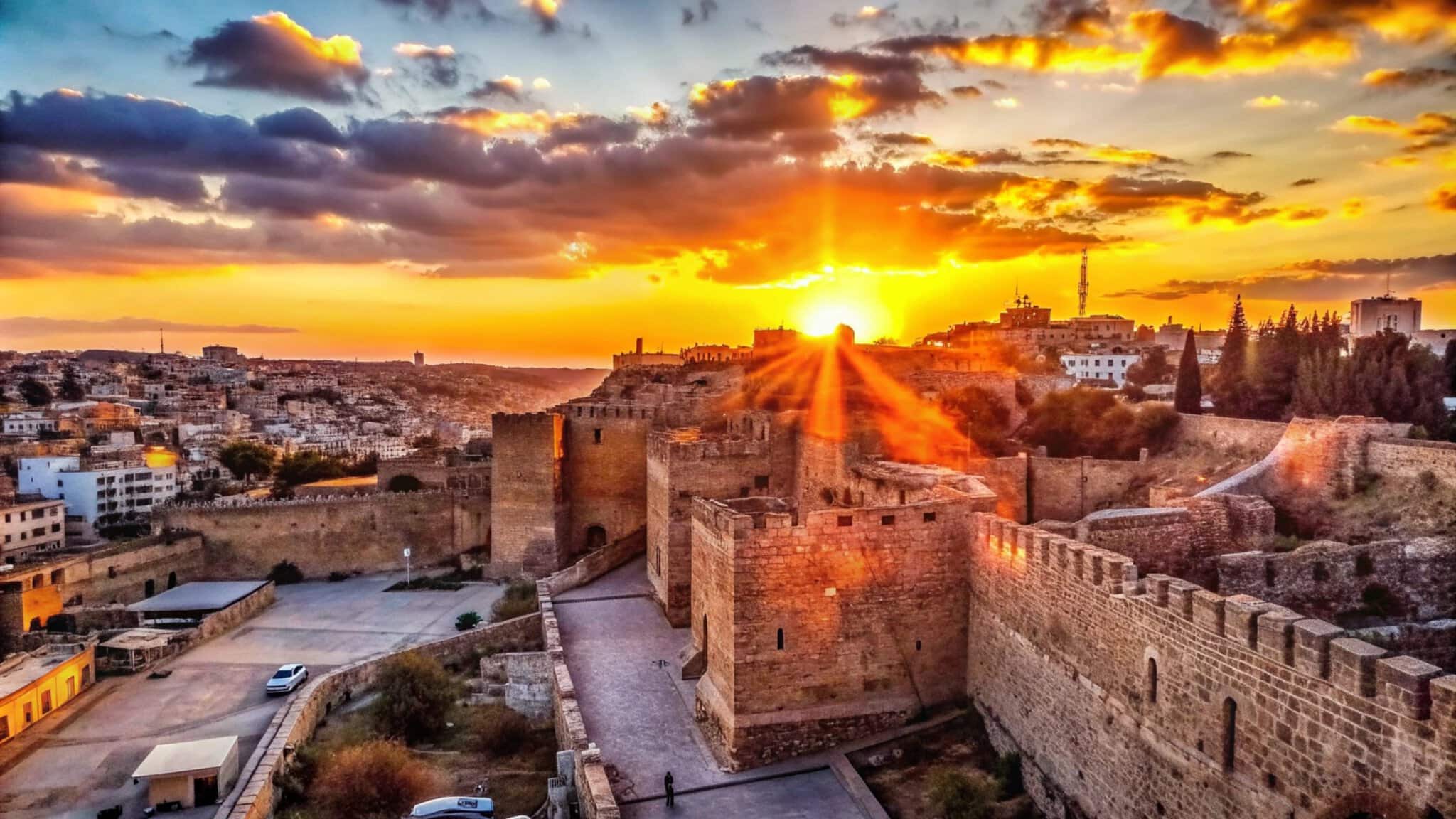 ancient-stone-castle-silhouetted-against-vibrant-sunset