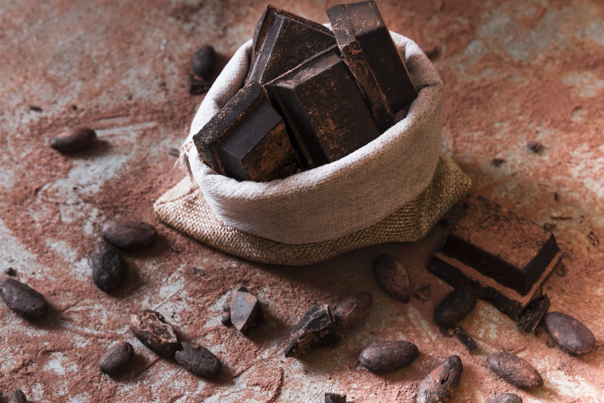 sack-chocolate-bar-pieces-cocoa-powder-beans-table